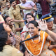 Indian policewomen detain protesting female activists in Kochi.